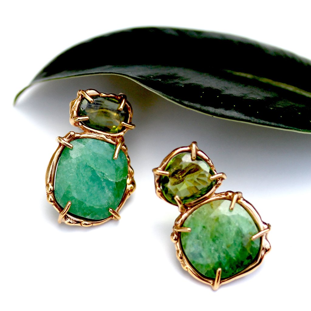 Emerald and peridot stud earrings in gold that have a refined organic quality.