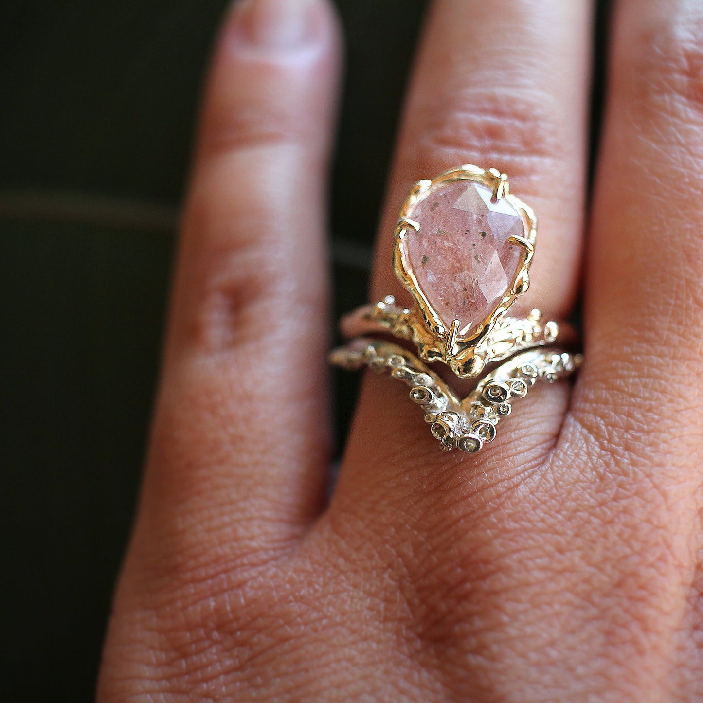 pink sapphire engagement ring with ocean inspired band in V arch
