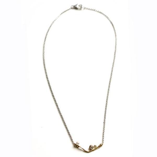 Yellow gold V-style necklace with three small accent diamonds.