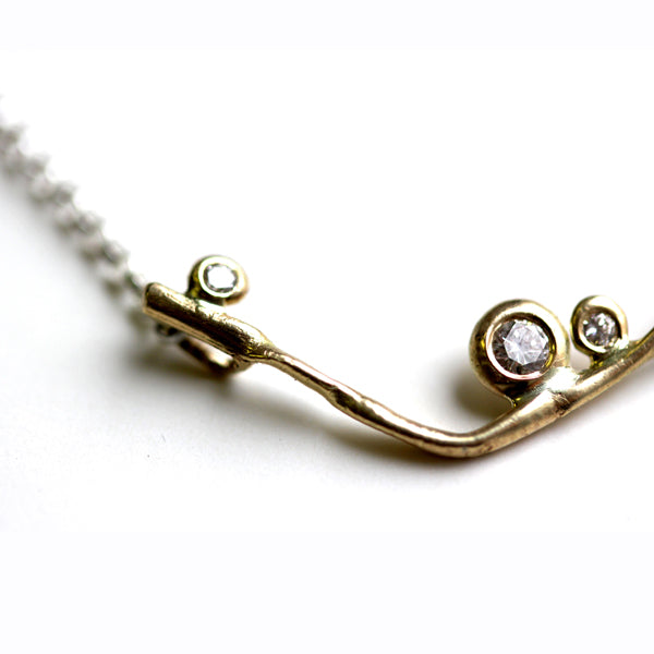 Detail photo of a V-style necklace with small accent diamonds.
