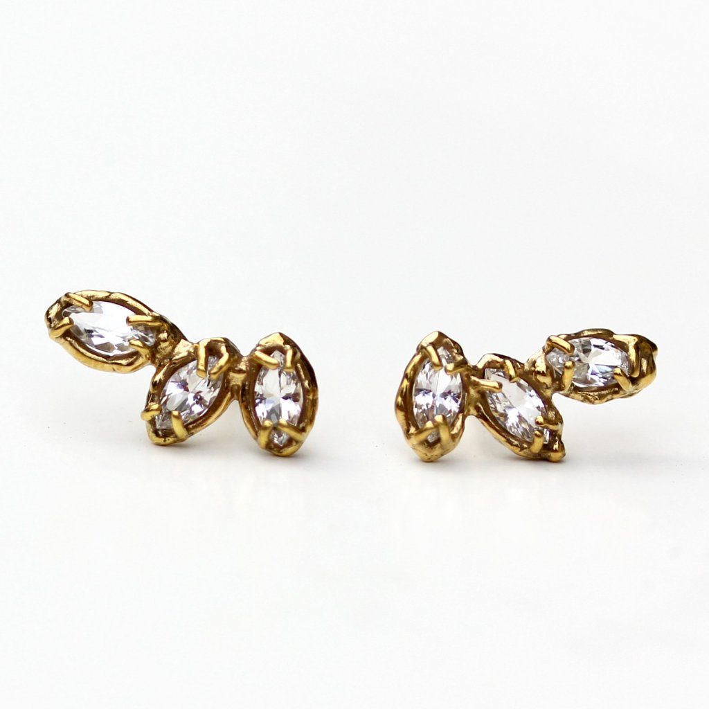 Stud earrings made of three marquise shaped white topaz stones set with organic prongs