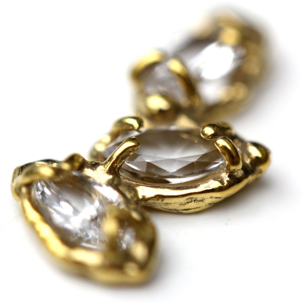 Detail photo of Stud earrings made of three marquise shaped white topaz stones set with organic prongs