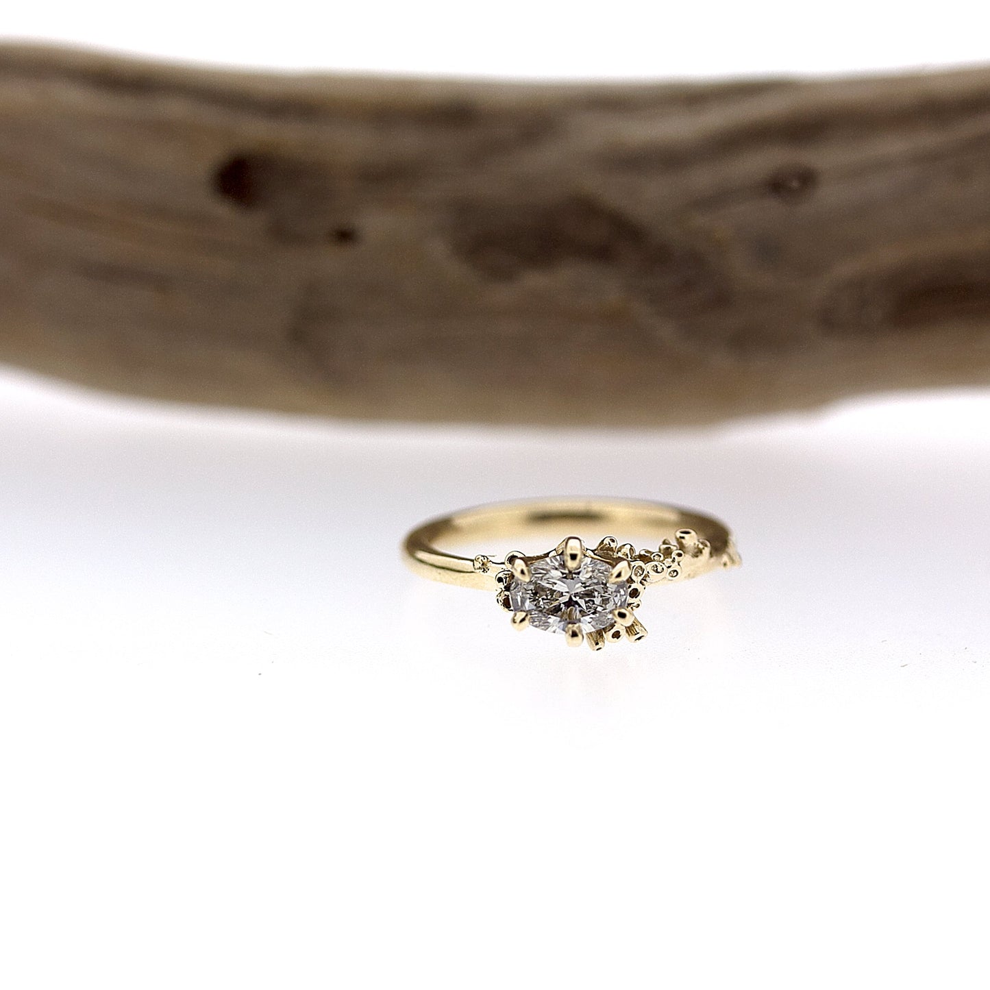 Full view of Cleopatra Diamond Engagement Ring with branch in background.