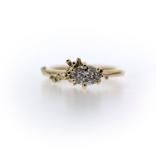 Full view of Cleopatra Diamond Engagement Ring. This ring is made of gold, has Katie's signature seasponge techniqueand a set ovular diamond at the top. 