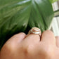 Detail shot of side of Corrina Ring on woman's finger to help give an idea of its scale.