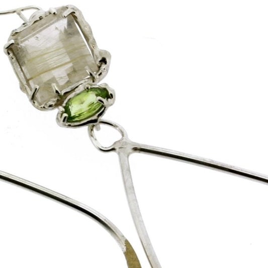 Slightly asymmetrical earrings handmade in sterling, rutilated quartz and peridot, a mismatched pair by Katie Poterala Studio