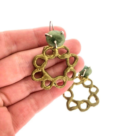 Full view of Emerald Wreath Earrings with hand in background to help give an idea of its scale.