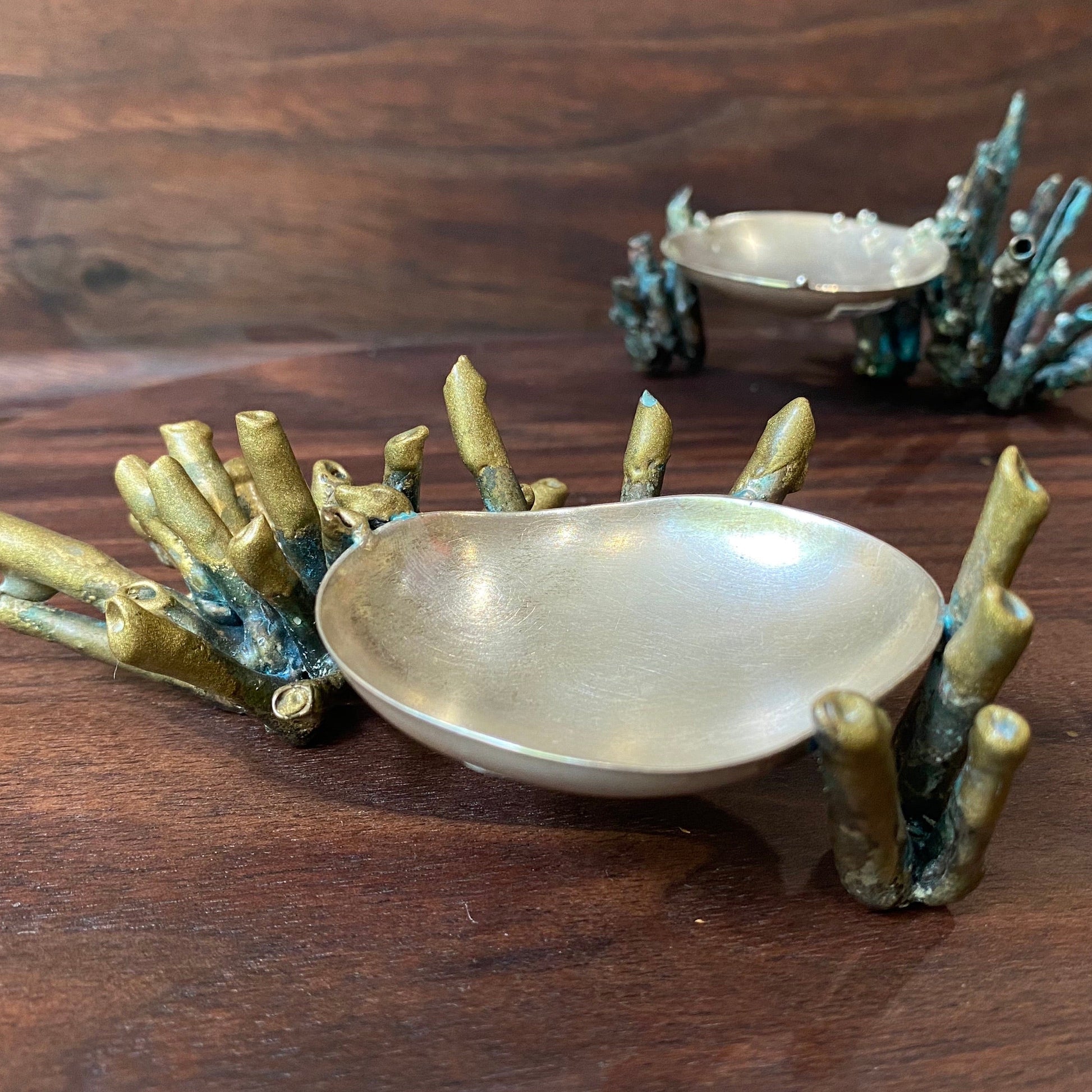 Full view of two Sea Sponge Trinket Dishes. Fabricated from Sterling Silver and patinated Brass, the details on this dish are inspired by sea sponge and coral.