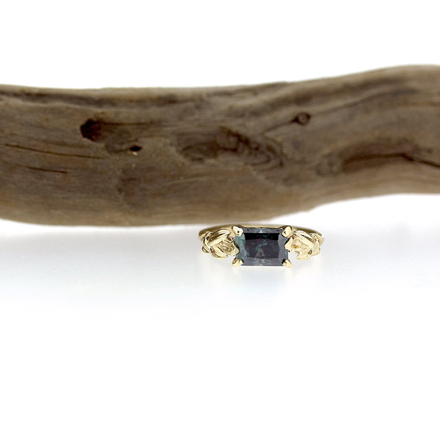 Full view of Kendra Moissanite Ring underneath a stick.