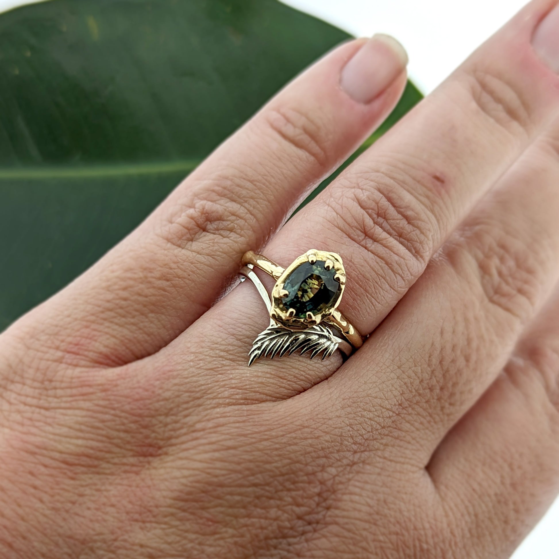 botanical leaf design nature inspired arched V shadow band wedding band, shown with parti sapphire engagement ring