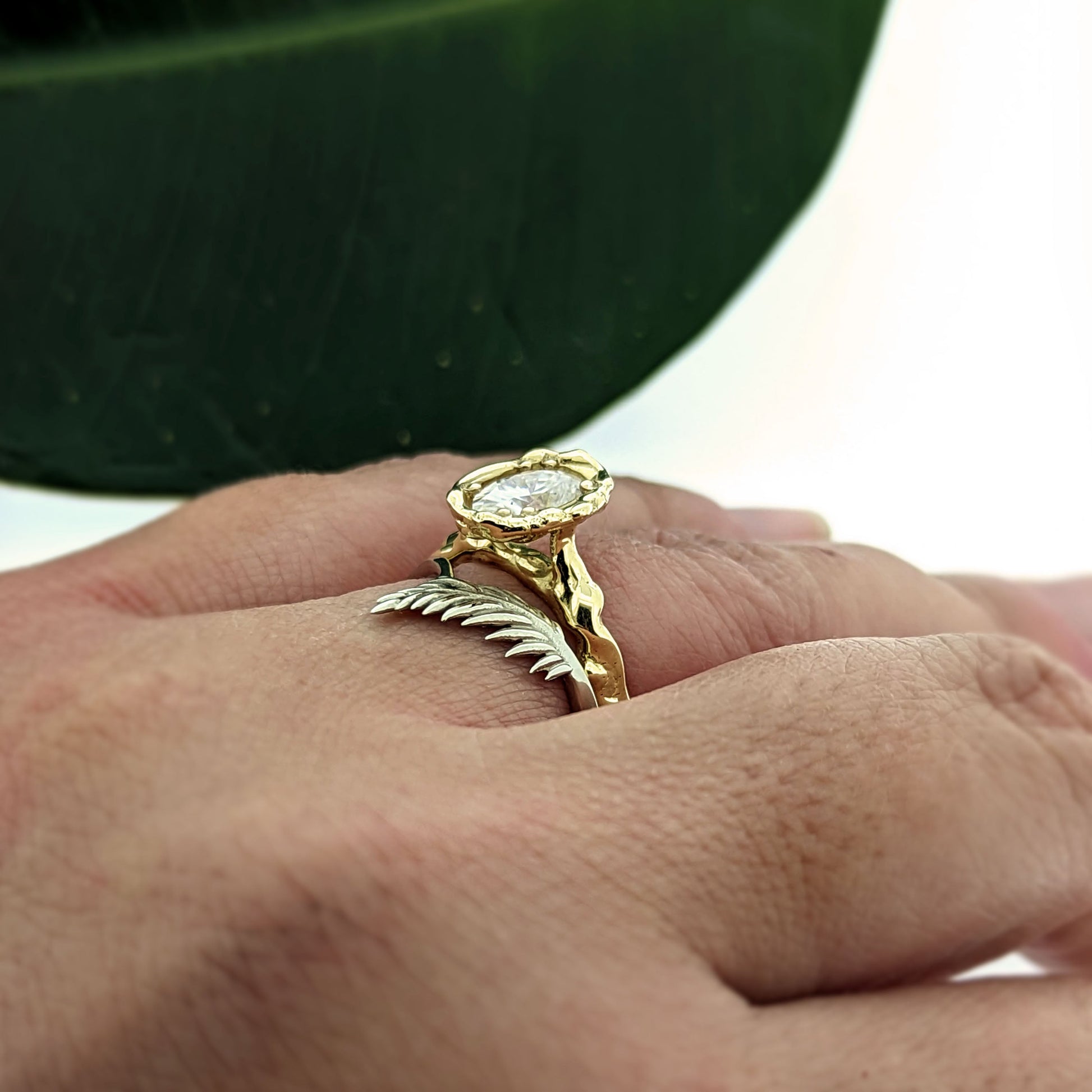 botanical leaf design nature inspired arched V shadow band wedding band , shown with oval moissanite organic twiggy engagement ring
