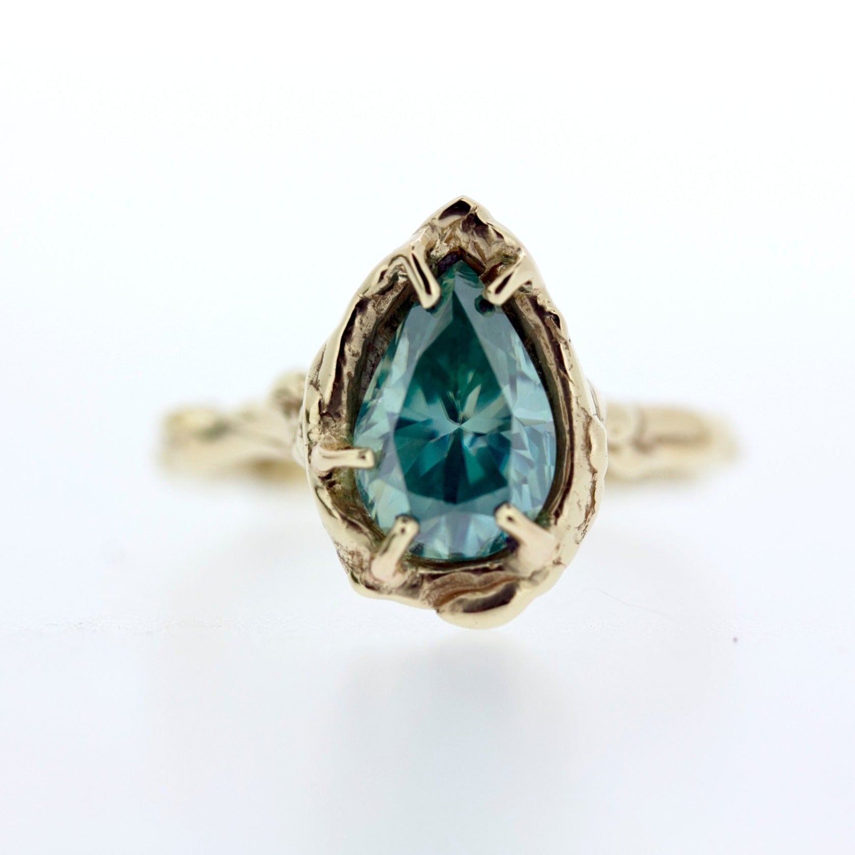 unique handmade teal moissanite engagement ring with hand wrought organic nature inspired dewdrop or water texture details