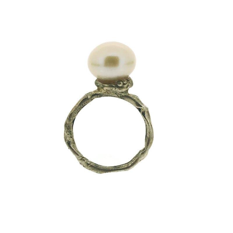 Full view of Organic Pearl Ring standing up. This ring features a set natural pearl on an organic silver band.