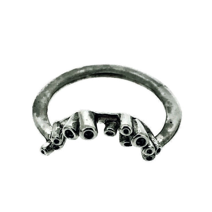 Angled view of Sea Sponge Small Curve Ring on white background.