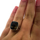 Full view of Smoky Quartz Simple Bezel Square Shank Ring on woman's finger to help give an idea of its scale. This ring showcases a rectangle cut smoky quarts set vertically in a silver bezel laying on a square shaped silver band.