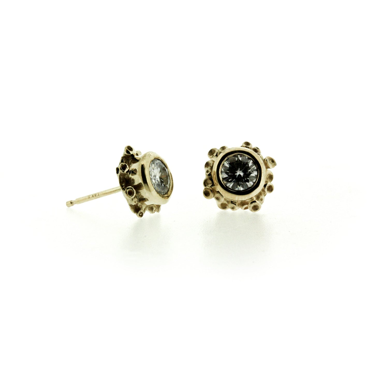 Front and side profile of Talialita Diamond. These stud earrings feature vibrant Moissanite or Diamonds set amidst an asymmetrical cluster of organic seasponge texture in gold.  