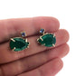 Full view of Green Onyx and Tanzanite Earrings with hand in background to help give an idea of its scale.